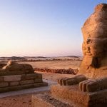 A photograph of the Great Sphinx of Giza in Egypt, framed against a clear blue sky.