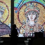 Professor Joan Branham discussing sacred architecture in front of a slide of an ancient mosaic floor from a Byzantine church.