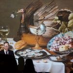 Dr. Paul Crenshaw standing before a slide of the Sistine Chapel ceiling, pointing to the 