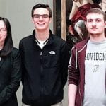 Professor Bing Huang and students posing in the Asian Art wing of a major museum.