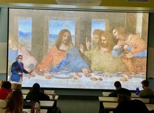 Students looking at a project of The Last Supper.