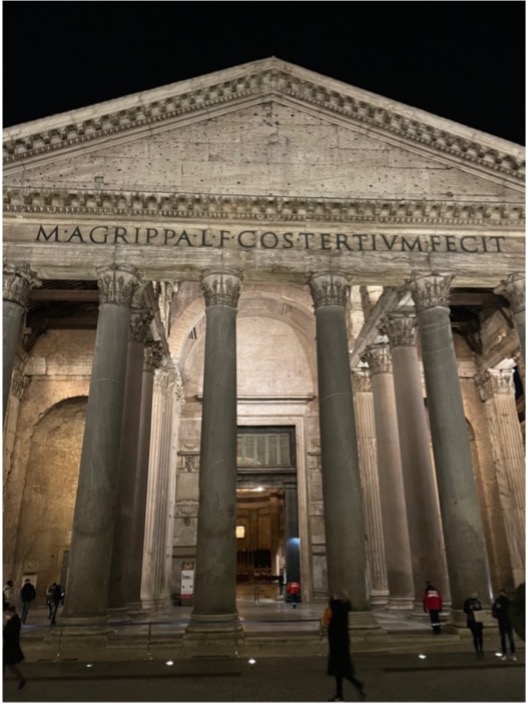 The front of the Pantheon  at night, lit up.