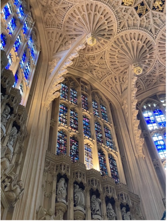 Vaulted interior ceiling with detailed relief work and many stained glass windows